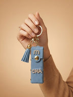 White mini wallet with gold tone studs and tassel Keychain | KCIN240