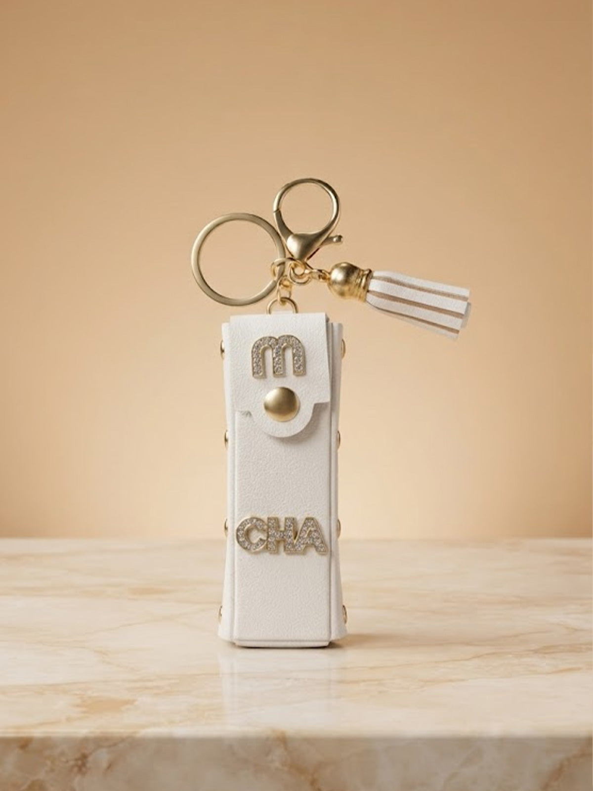White mini wallet with gold tone studs and tassel Keychain | KCIN251