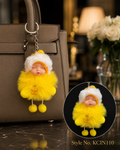 Yellow hooded plush baby doll with fluffy coat and pom details Keychain | KCIN110