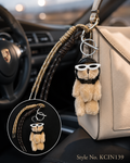 Brown oval charm with flower detail and braided cords Keychain | KCIN139
